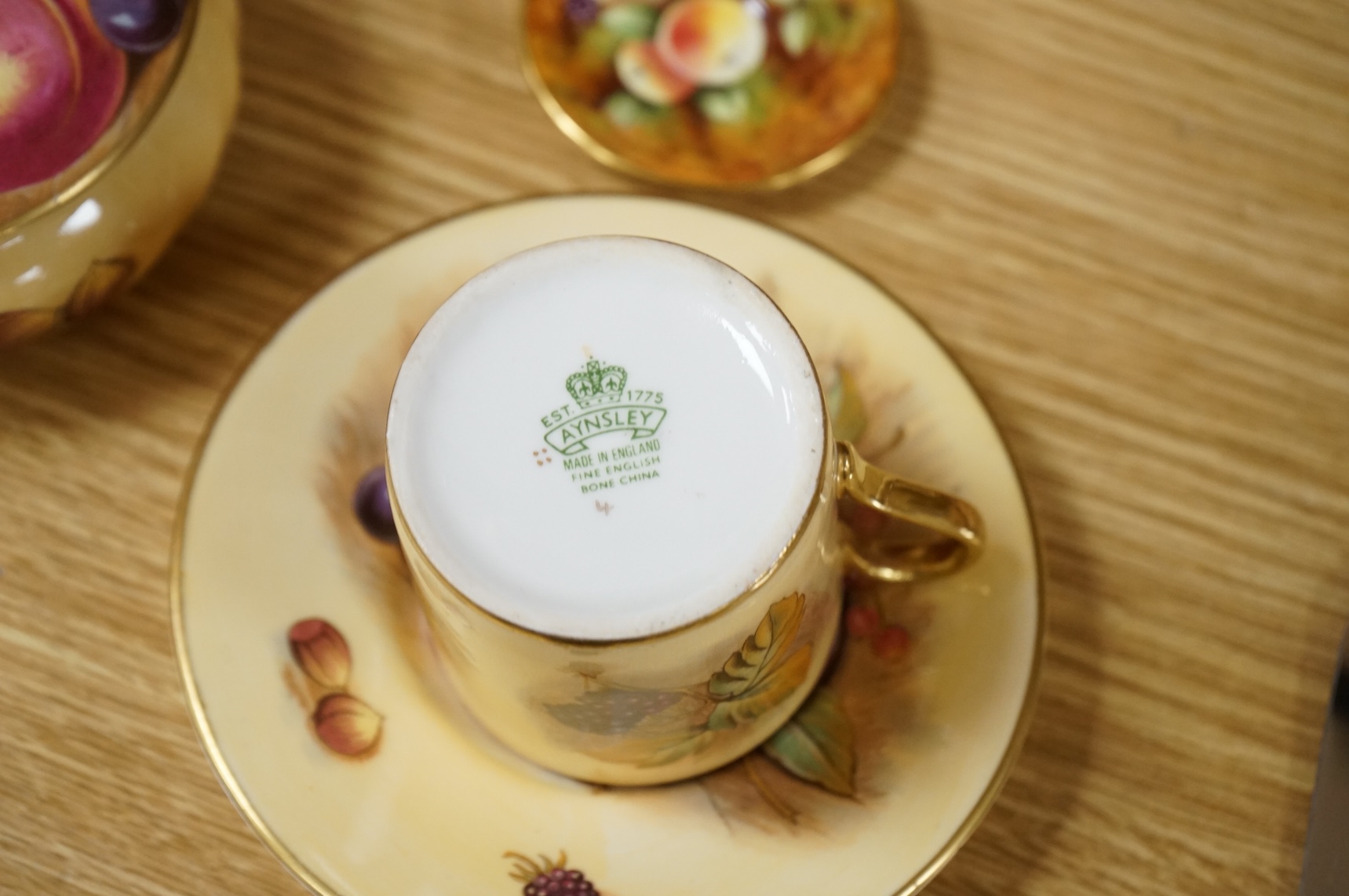 A collection of Aynsley ‘Orchard Gold’ fruit-painted tea/dinner wares and vases, largely signed by D Jones, largest 26cm in diameter
